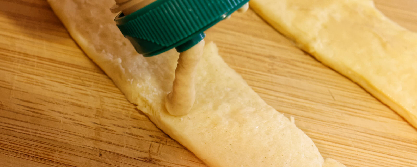 Spreading mustard on the dough